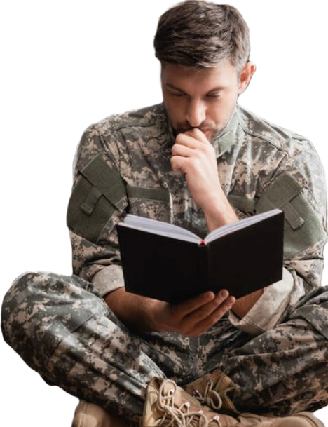 Picture of a veteran sitting and reading a book.